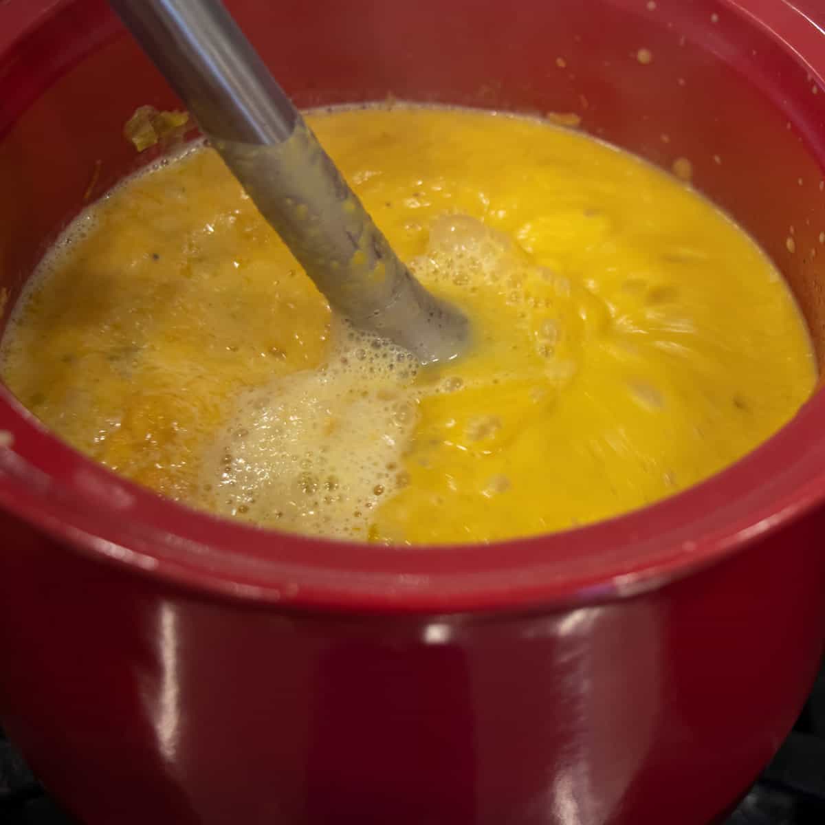 Making the soup creamy with an immersion blender.