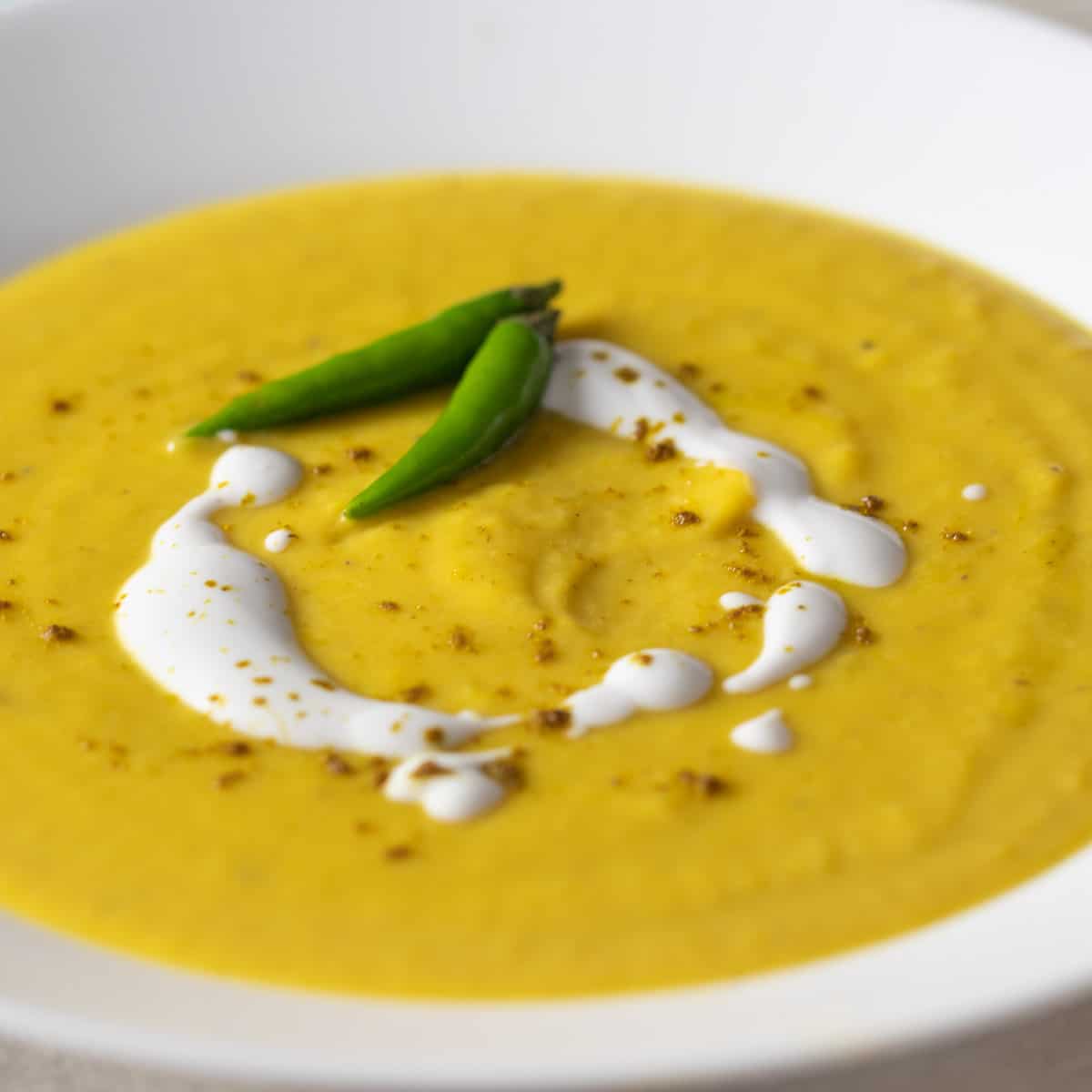 A closeup picture of a bowl of squash soup.