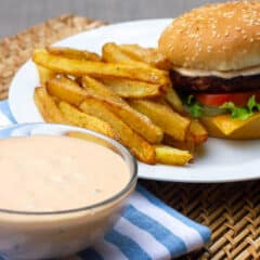 A bowl of Big Mac secret sauce with a burger and fries.