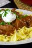 Beef pasta dish on a white plate.