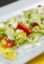 A close up of a salad made with zucchini and yellow squash.