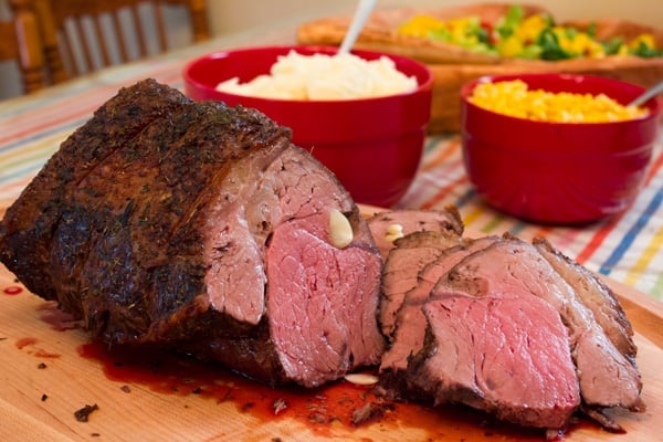 Cooked sirloin beef roast sliced on a cutting board