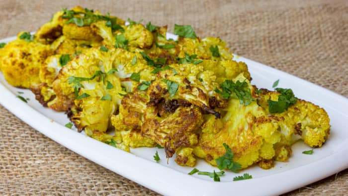 Roasting cauliflower brings out the sweet caramelized flavor of each floret. Toss with curry powder, garlic powder, turmeric and oil. Then squeeze lemon juice and sea salt.