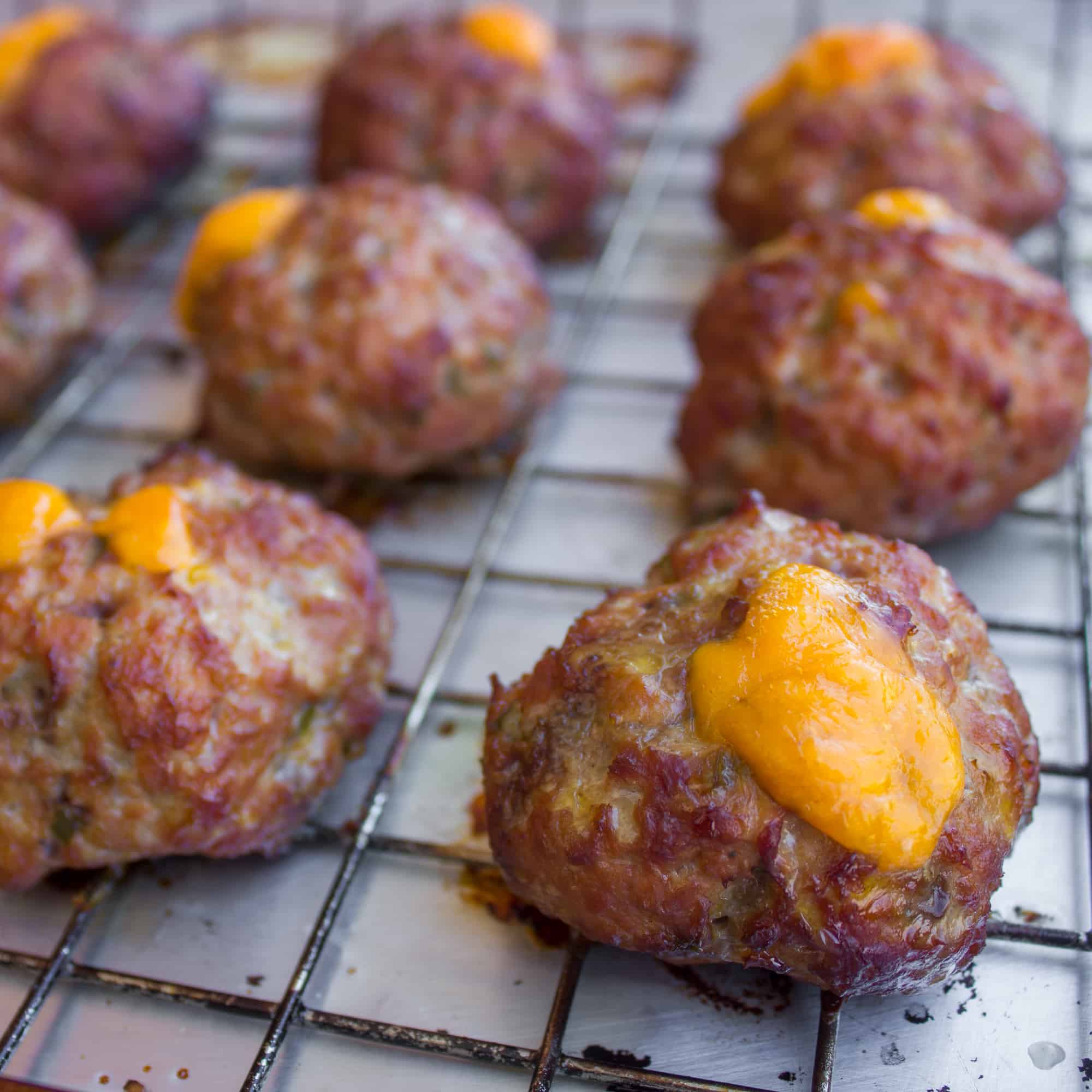 These pork meatballs are stuffed with cheddar cheese and jalapeno peppers and smoked in a Bradley smoker. Delicious, cheesy and a little spicy too!