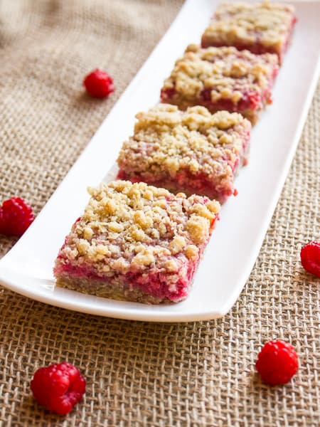 These dessert squares with raspberries and oat crumble are sweet, tangy and totally delicious. Raspberries, oats, brown sugar, butter, flour and more