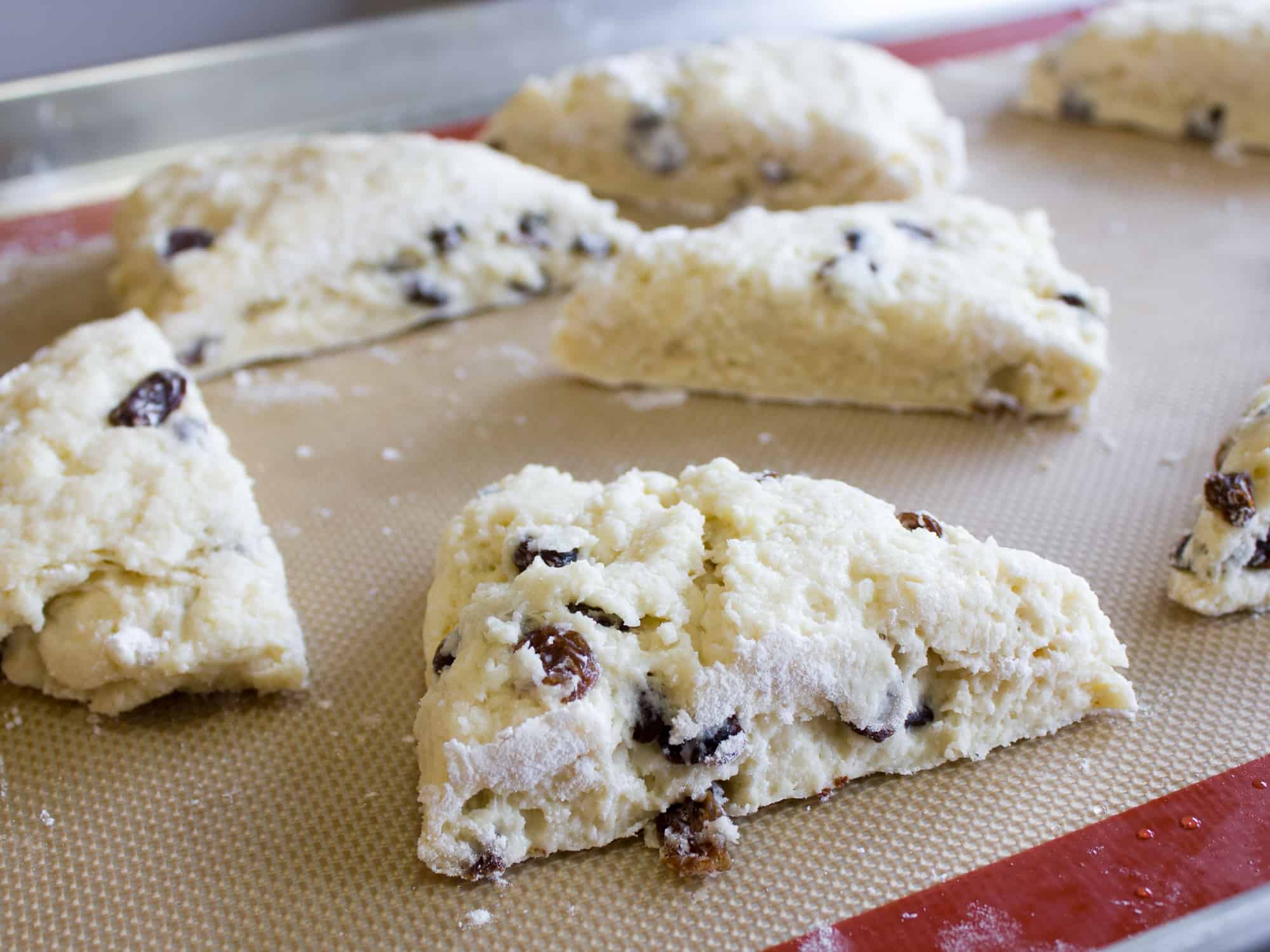 These raisin scones are buttery and flaky baked biscuits. Super easy to make and bake. The raisins can be substituted with dried cranberries or some fresh blueberries, strawberries etc.