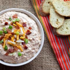 Overhead picture of a bowl of dip with toasted baguettes