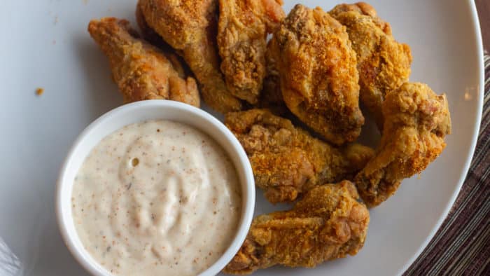 Crispy deep fried chicken wings tossed in a homemade spicy Cajun spice rub seasoning blend. Served with some Creole Buttermilk Ranch dip.