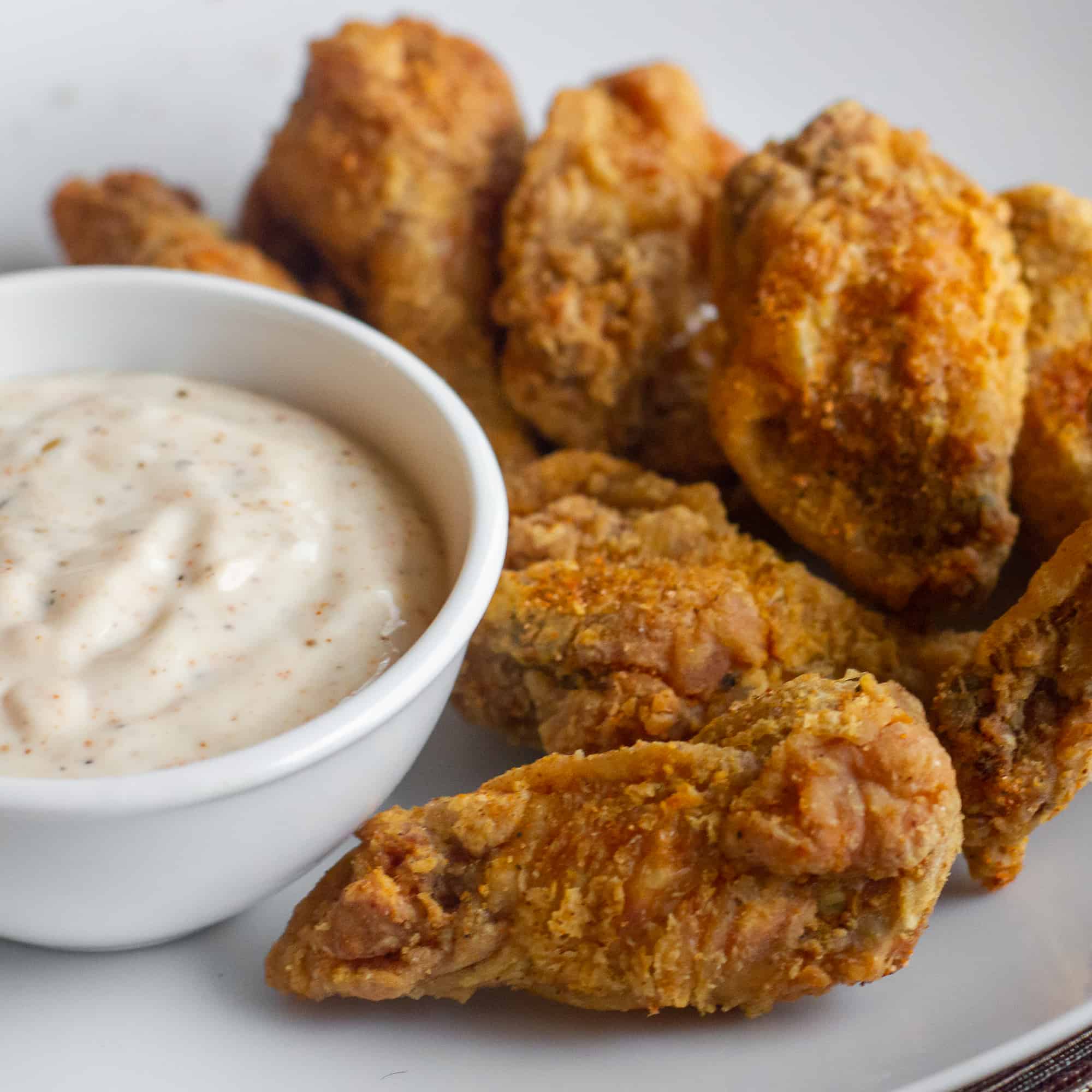 Crispy deep fried chicken wings tossed in a homemade spicy Cajun spice rub seasoning blend. Served with some Creole Buttermilk Ranch dip.