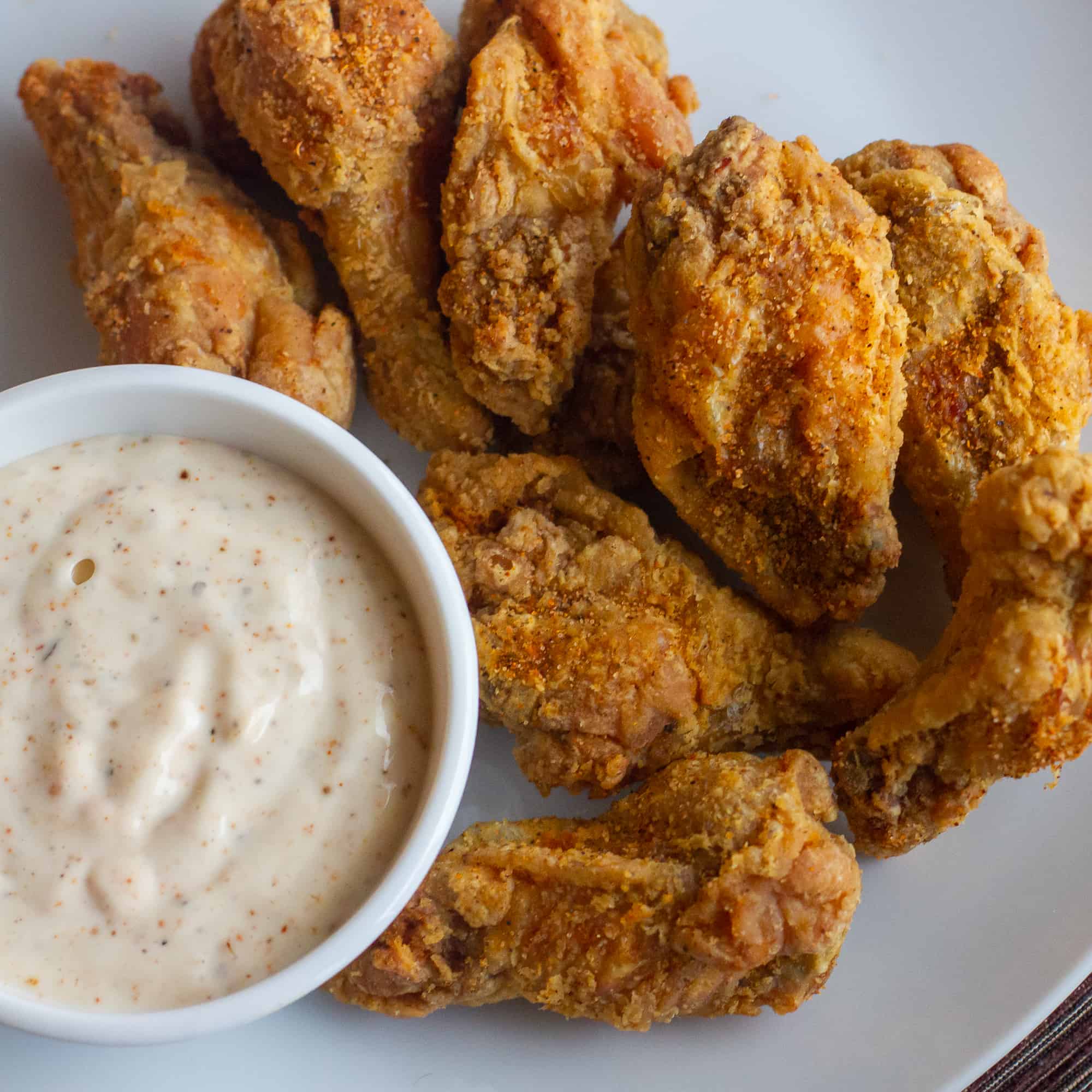 Crispy deep fried chicken wings tossed in a homemade spicy Cajun spice rub seasoning blend. Served with some Creole Buttermilk Ranch dip.