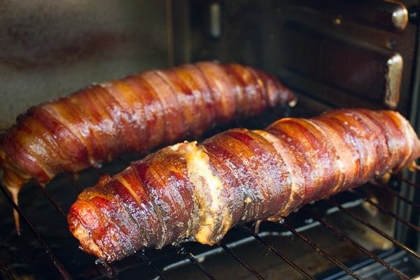 Bacon Wrapped Smoked Pork Tenderloin Stuffed with Roasted Red Peppers and Cheese in smoker