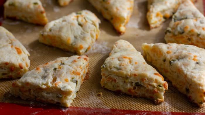 Fresh baked cheddar jalapeno scones are biscuits that have lots of cheddar cheese and minced pickled jalapeño peppers. Best served warm with soup or chili!