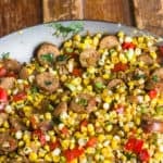 Fried corn cut off the cob and sausage make a delicious side dish. How to make instructions using a carbon steel or cast iron skillet