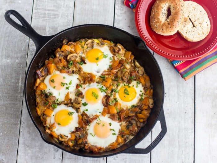 An overhead image of baked eggs in a cast iron skillet.