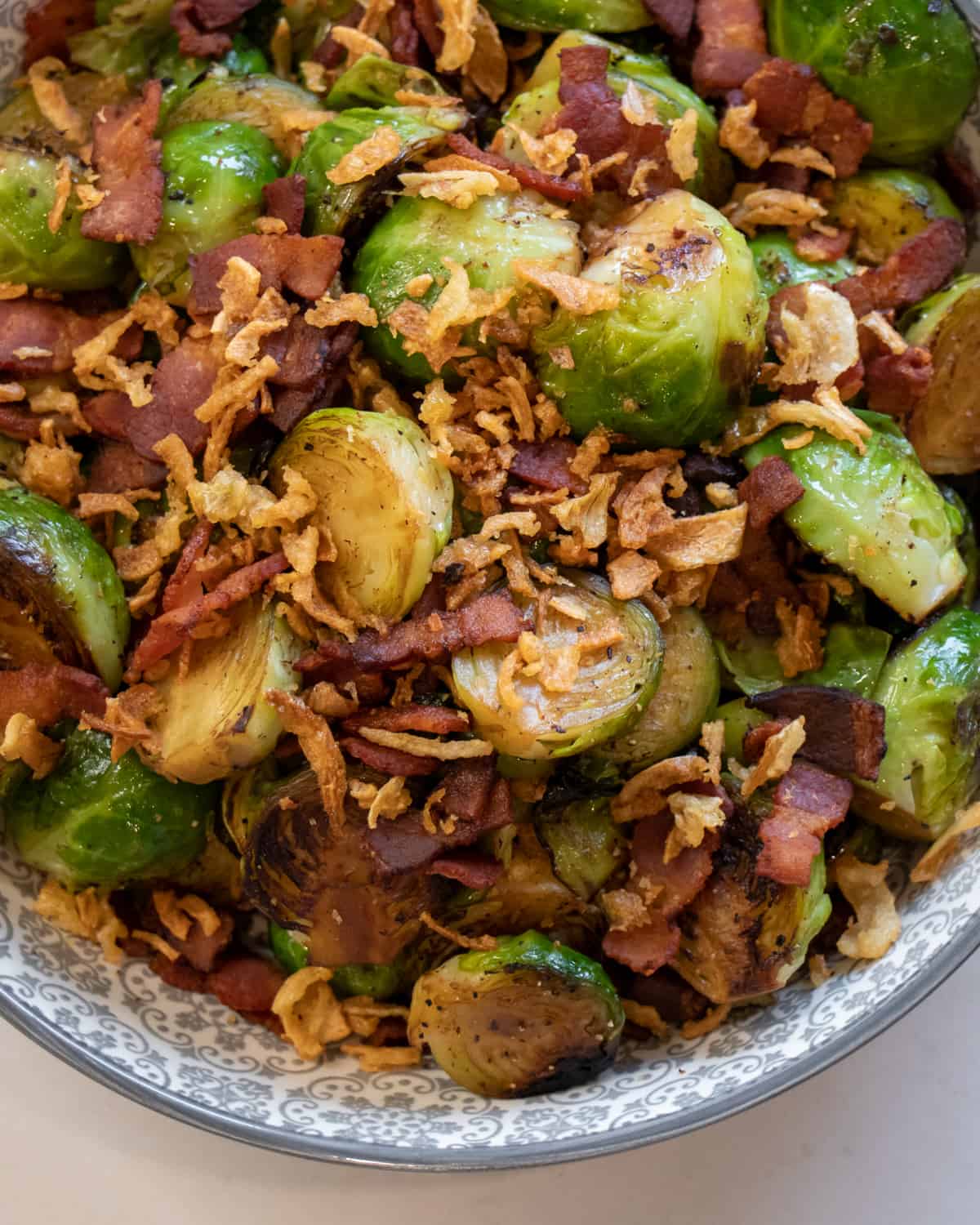 Fried Brussels sprouts with bacon and fried onions.