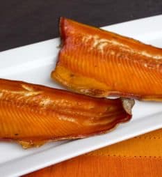 Wood smoked rainbow trout that has been marinated in a sweet wet brine. Simple instructions and recipe for how to smoke a rainbow trout.