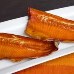 Wood smoked rainbow trout that has been marinated in a sweet wet brine. Simple instructions and recipe for how to smoke a rainbow trout.