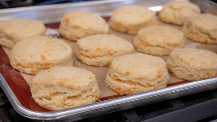 Simple recipe for how to bake cheddar cheese biscuits that are buttery, flakey and simple to make in the oven. Fresh baked and similar to Red Lobster's Cheddar Bay biscuits.