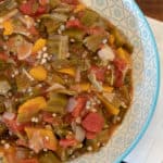 Simple recipe for how to make stewed okra southern side dish. Creole and cajun style with tomatoes, onions and peppers.