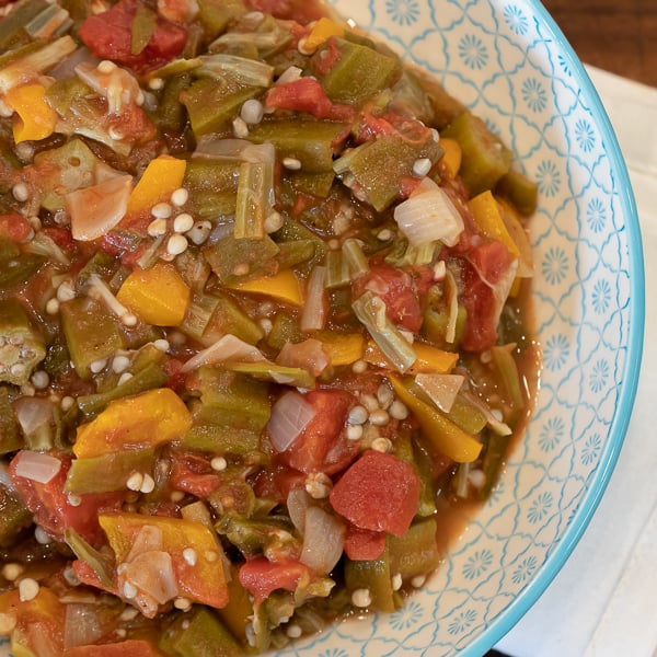 Simple recipe for how to make stewed okra southern side dish. Creole and cajun style with tomatoes, onions and peppers.