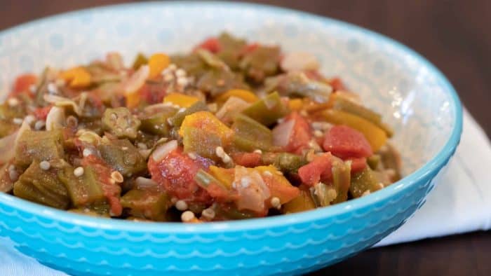 Simple recipe for how to make stewed okra southern side dish. Creole and cajun style with tomatoes, onions and peppers.