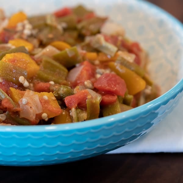 Simple recipe for how to make stewed okra southern side dish. Creole and cajun style with tomatoes, onions and peppers.