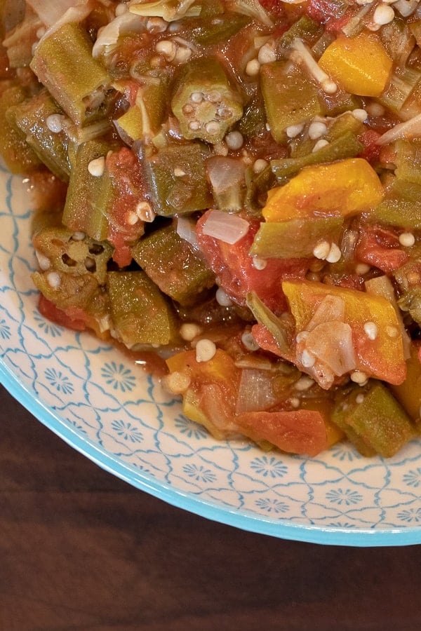 Simple recipe for how to make stewed okra southern side dish. Creole and cajun style with tomatoes, onions and peppers.