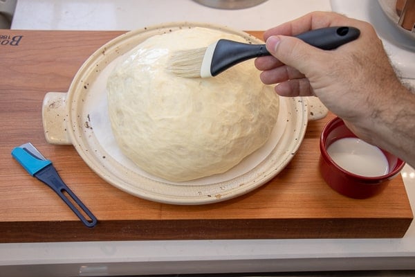 Simple to make rustic artisan bread recipe that can be baked in a clay bread cloche, dutch oven, or baking sheet.