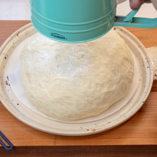 Simple to make rustic artisan bread recipe that can be baked in a clay bread cloche, dutch oven, or baking sheet.