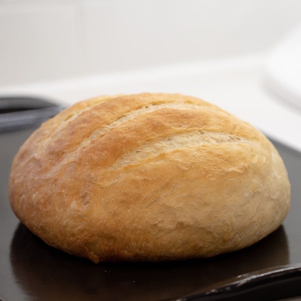 Cheesy pull apart bread made with an artisan rustic round bread loaf, sliced and filled with grated cheddar cheese, crumbled bacon and sliced green onions. Baked until cheese is bubbly!