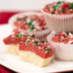 A sweet mini candy cup made with melted white chocolate, crumbled shortbread, crushed candy canes and red candy melts. The perfect sweet treat for Christmas holidays.