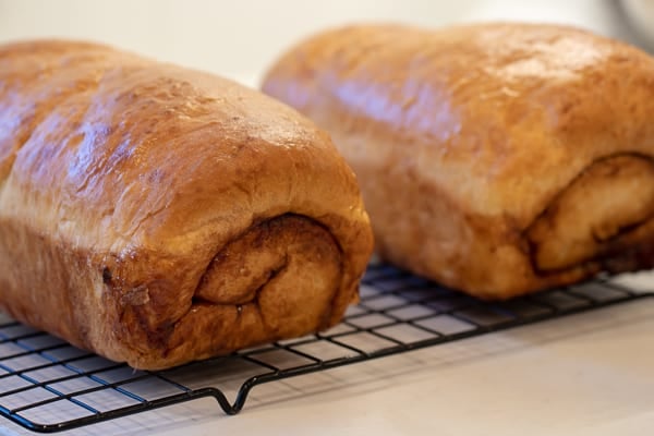 Easy instructions for how to bake cinnamon swirl bread. This recipe makes 2 loaves of fresh sweet cinnamon bread that is great with butter, toasted or used as french toast! Just like a bakery made right at home!