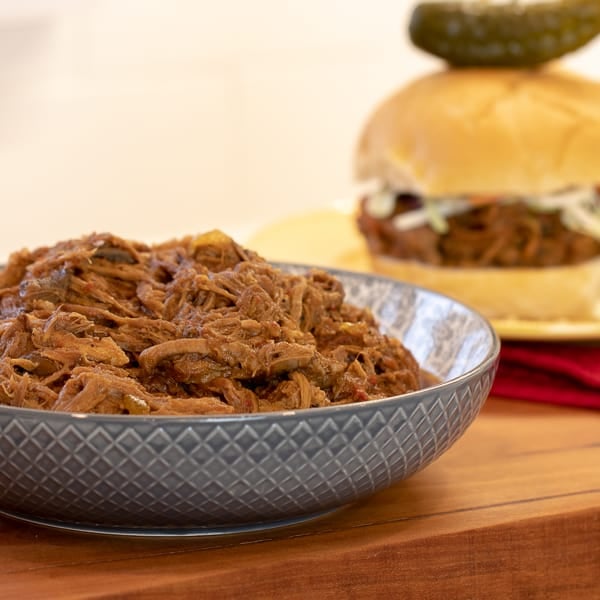 How to make pulled pork in a pressure cooker like an Instant Pot. Simple recipe that uses a pork roast, like a shoulder, blade or picnic, can of pop, BBQ sauce, onion, peppers, celery and mushrooms for a pulled pork full of flavour!