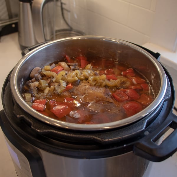 How to make pulled pork in a pressure cooker like an Instant Pot. Simple recipe that uses a pork roast, like a shoulder, blade or picnic, can of pop, BBQ sauce, onion, peppers, celery and mushrooms for a pulled pork full of flavour!