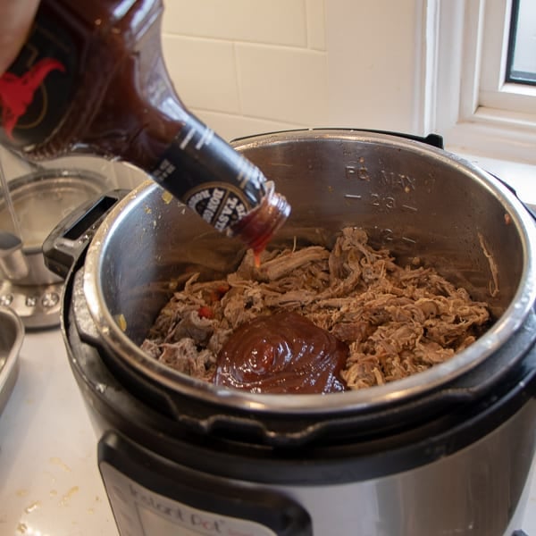 How to make pulled pork in a pressure cooker like an Instant Pot. Simple recipe that uses a pork roast, like a shoulder, blade or picnic, can of pop, BBQ sauce, onion, peppers, celery and mushrooms for a pulled pork full of flavour!