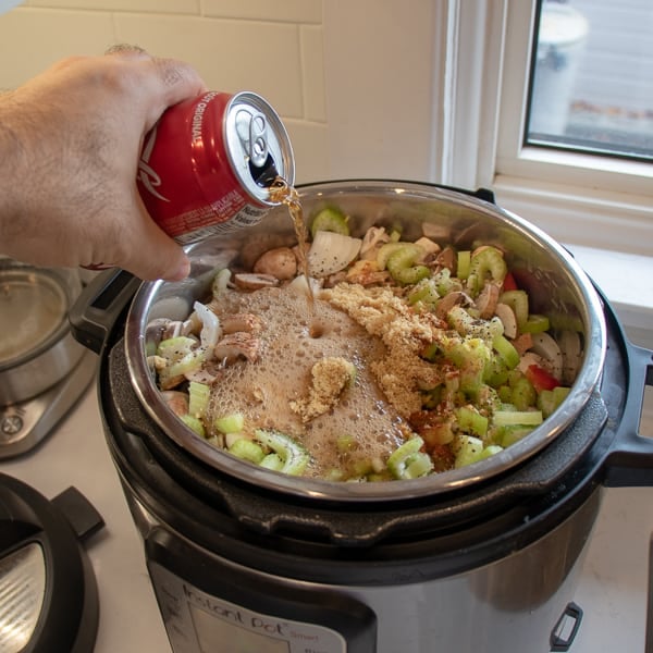 How to make pulled pork in a pressure cooker like an Instant Pot. Simple recipe that uses a pork roast, like a shoulder, blade or picnic, can of pop, BBQ sauce, onion, peppers, celery and mushrooms for a pulled pork full of flavour!