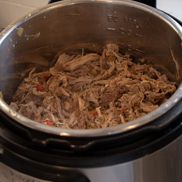 How to make pulled pork in a pressure cooker like an Instant Pot. Simple recipe that uses a pork roast, like a shoulder, blade or picnic, can of pop, BBQ sauce, onion, peppers, celery and mushrooms for a pulled pork full of flavour!