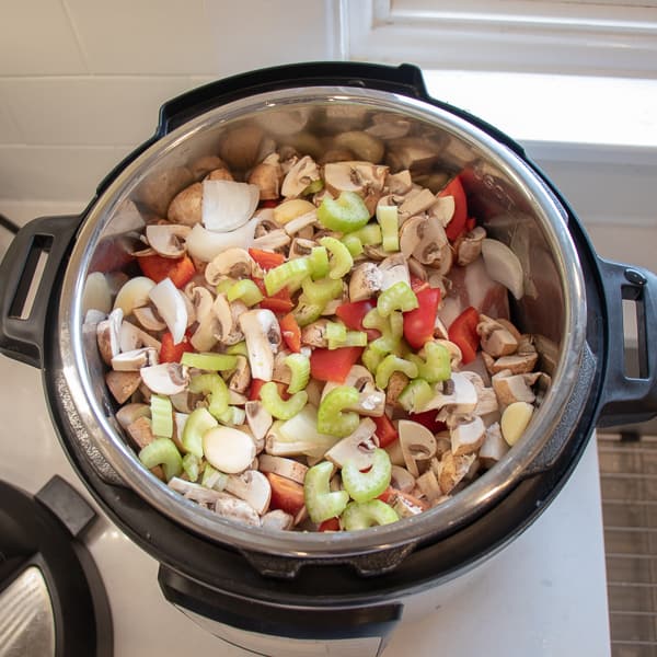 How to make pulled pork in a pressure cooker like an Instant Pot. Simple recipe that uses a pork roast, like a shoulder, blade or picnic, can of pop, BBQ sauce, onion, peppers, celery and mushrooms for a pulled pork full of flavour!