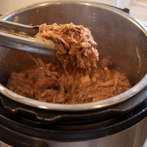 How to make pulled pork in a pressure cooker like an Instant Pot. Simple recipe that uses a pork roast, like a shoulder, blade or picnic, can of pop, BBQ sauce, onion, peppers, celery and mushrooms for a pulled pork full of flavour!