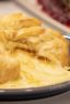 Delicious appetizer recipe of baked brie cheese wrapped in puff pastry with apricot jam and walnuts.