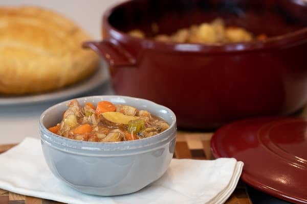 Delicious recipe and instructions for how to make pork stew in a dutch oven with pork tenderloin, potatoes, carrots, onions, mushrooms, celery and more.