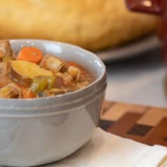 Hearty stew in a grey soup bowl.