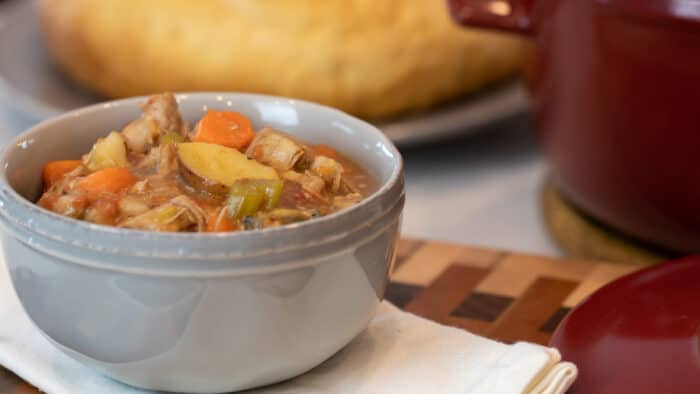 Hearty stew in a grey soup bowl.