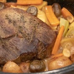 Easy recipe and instructions for how to cook a sirloin tip roast in the oven so that it is well done but also tender, juicy and delicious. Vegetables include carrots, potatoes, onions, mushrooms, celery and garlic.