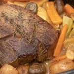 Easy recipe and instructions for how to cook a sirloin tip roast in the oven so that it is well done but also tender, juicy and delicious. Vegetables include carrots, potatoes, onions, mushrooms, celery and garlic.