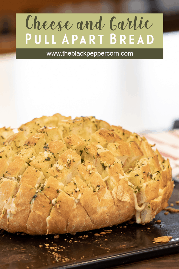 Cheese and Garlic Pull Apart Bread - Made with an artisan rustic round bread loaf, sliced and filled with grated mozzarella cheese, minced garlic, melted butter and parsley. Baked until cheese is bubbly!