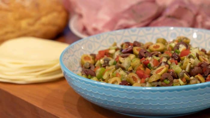 Olive salad spread recipe for muffuletta sandwich made with green and kalamata olives as well as roasted red peppers, capers, celery and green onions.