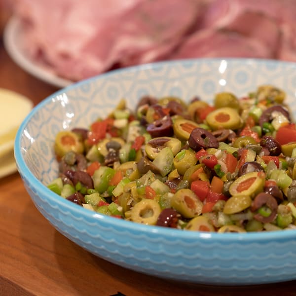 Olive salad spread recipe for muffuletta sandwich made with green and kalamata olives as well as roasted red peppers, capers, celery and green onions.