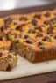 This chewy peanut butter blondie has mini Reese' Pieces, chopped peanut butter cup minis and chocolate chips. A delicious dessert and alternative to a brownie.