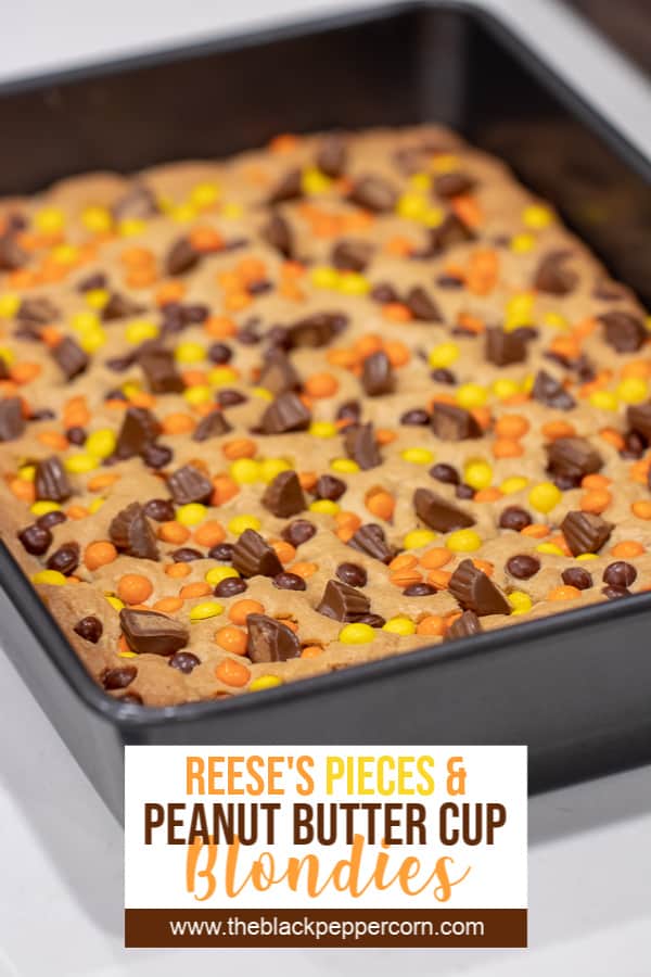 This chewy peanut butter blondie has mini Reese' Pieces, chopped peanut butter cup minis and chocolate chips. A delicious dessert and alternative to a brownie.